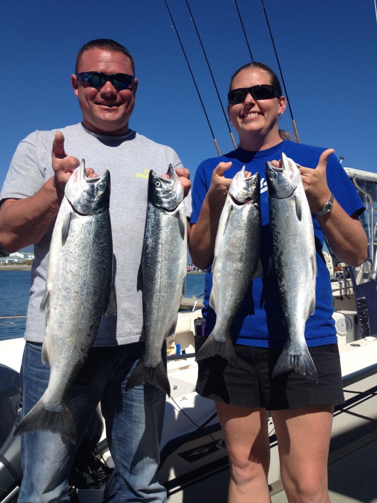 Happy guests with their coho after a great day on the water!